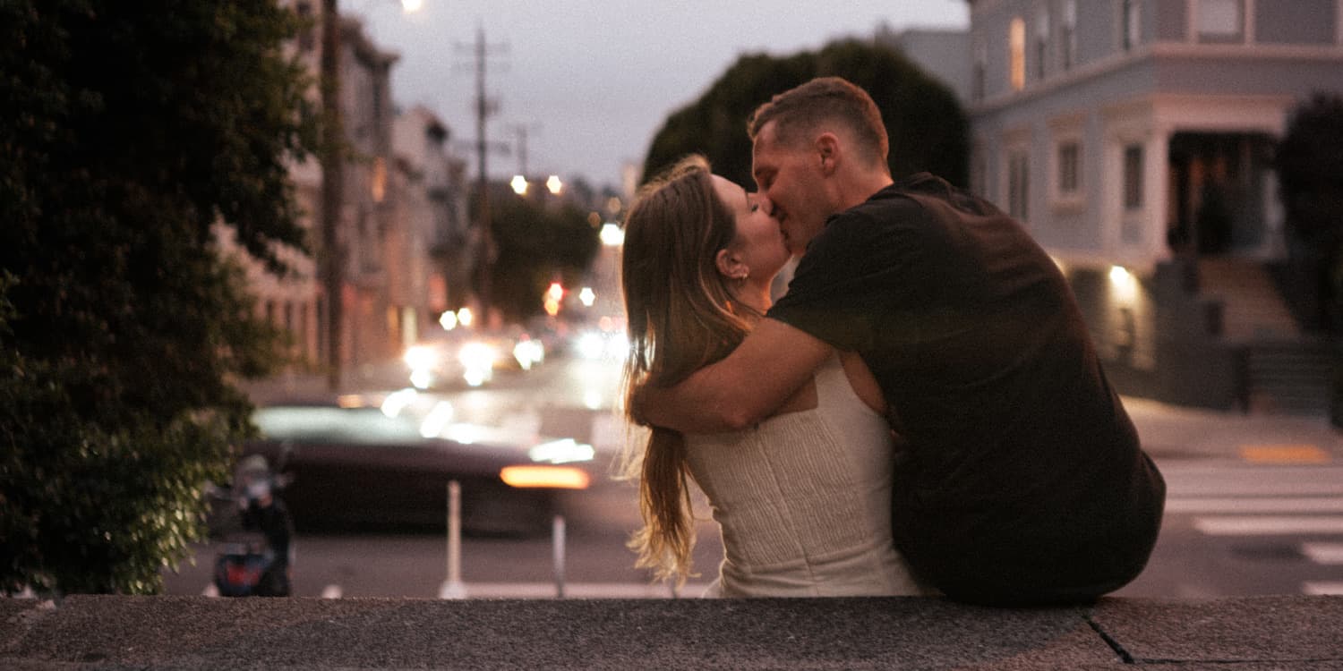 Thomas and Victoria kiss at dusk in San Francisco.